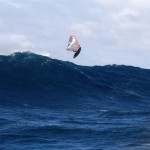 soaring over a wall of water in a chop hop down the face