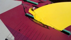 Push down on the fin with the shim in place over the slot.