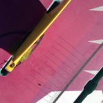 With the shim wrapped evenly around the base, push the fin in the board.