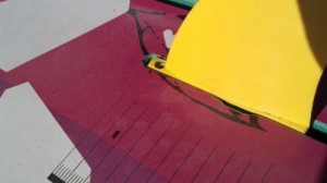 Push the fin into the slot so that it is flush with the board and the shim is not sticking out.