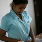 Nirosha concentrates on her taping. Taping is important before sewing.