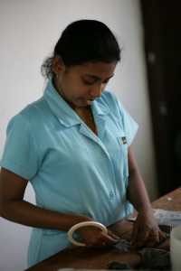 Nirosha concentrates on her taping. Taping is important before sewing.