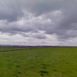 The beauty of Ireland-- dark clouds against rich green fields.