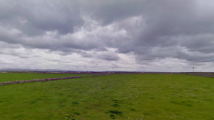 The beauty of Ireland-- dark clouds against rich green fields.