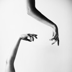 This photo could be read as dismembered arms reaching out in space without hope of contact-- but I prefer to look at the beauty of the flower-like hands making such nice negative space.